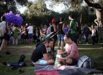 Two Israeli men play with their child during a rally before the parade in Jerusalem. 