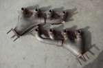 Factory stainless steel exhaust manifold for GM 454 engine as used in trucks and recreational vehicles.